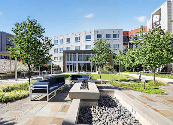 A modern building with a courtyard in front of it.