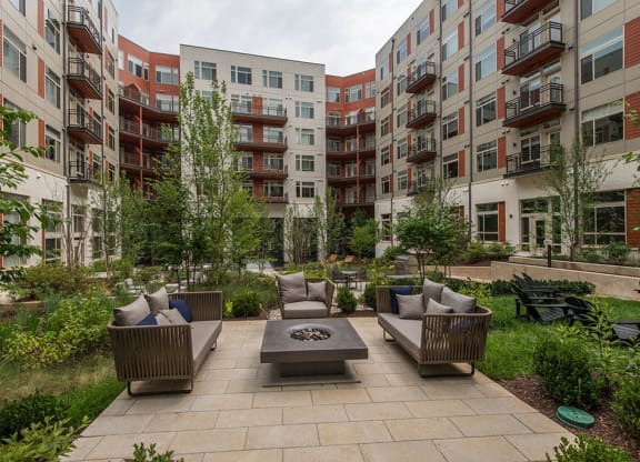 Outdoor courtyard with couches and a fire pit at Highgate At The Mile in McLean, Virginia 22102