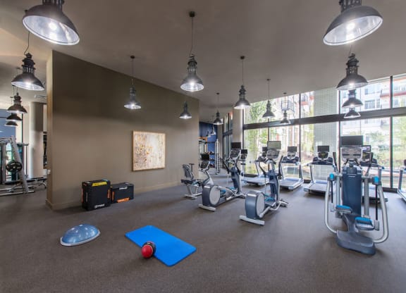 Fitness center with treadmills and other exercise equipment at Highgate at Highgate at the Mile, Virginia