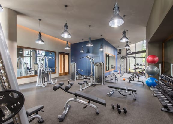 Workout room with weights and other exercise equipment at Highgate at the Mile, McLean