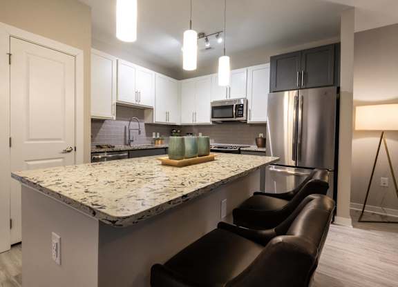 A Kitchen With Refrigerator at The Aster Cary, Cary