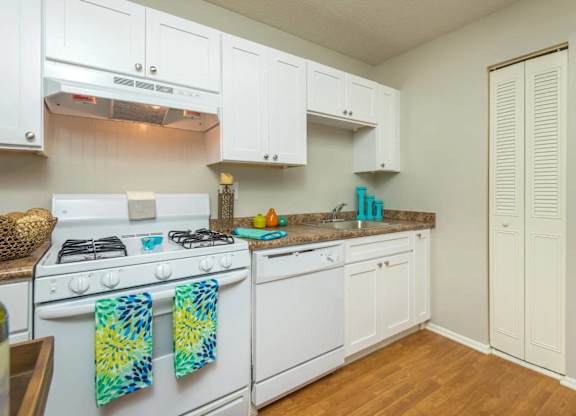 A kitchen with white appliances at The Pointe at Midtown, North Carolina