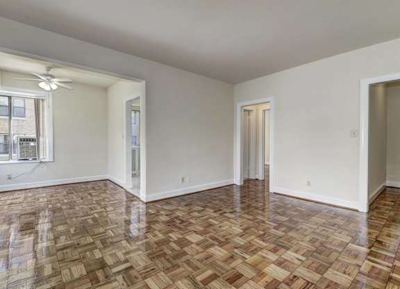 A room with a wooden floor and white walls.
