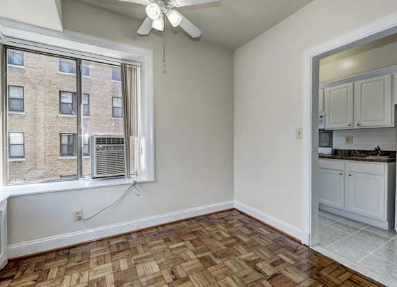 A room with a window and a ceiling fan.