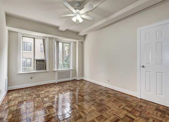 A room with a wooden floor and a ceiling fan.