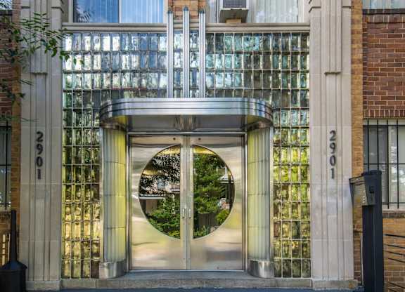A modern gate with a circular window in the middle.