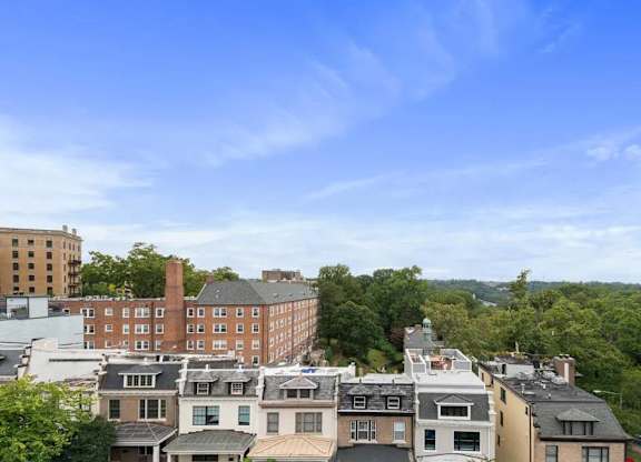 A view of a cityscape with buildings and trees.