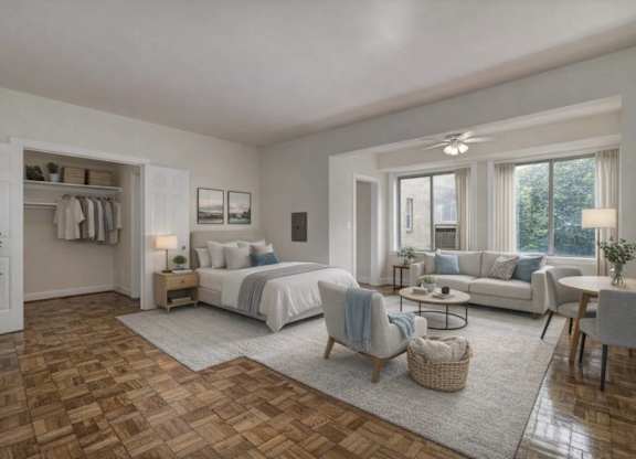 A bedroom with a large bed, a couch, and a chair in the foreground.