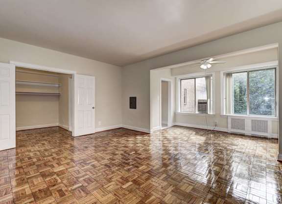A room with a wooden floor and a ceiling fan.