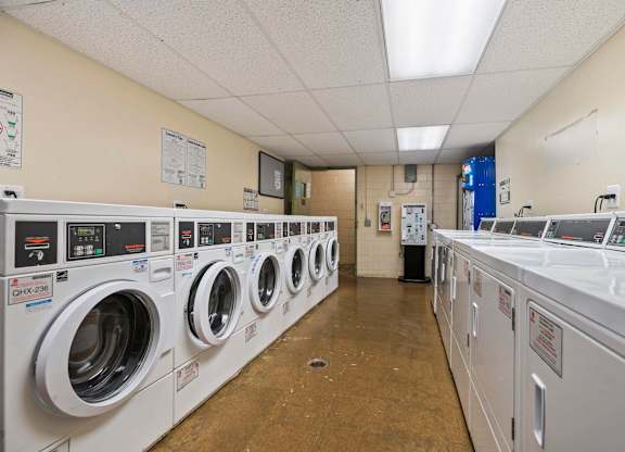 A row of washing machines in a laundromat.