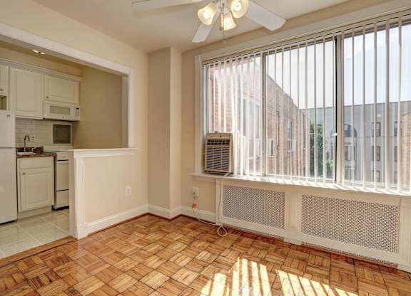 A sunny kitchen with a fan and a window.