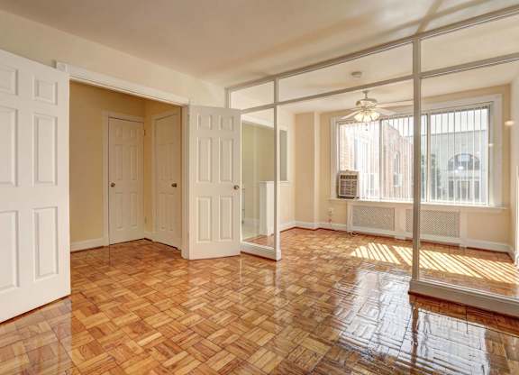 A room with wooden flooring and white doors.