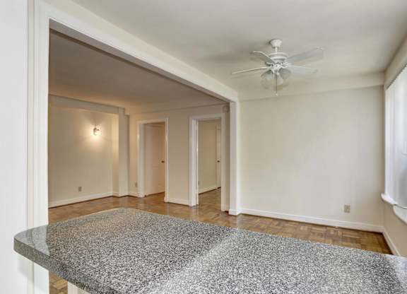 Spacious bedroom with hardwood floors and ceiling fan at Tivoli Gardens Apartments, Washington, DC