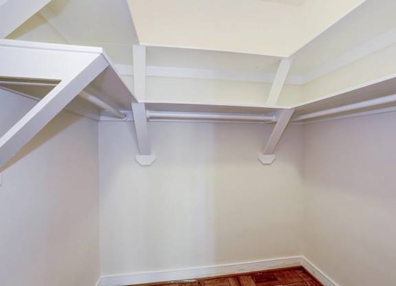 Walk-in closet with hanging rods and shelving at Tivoli Gardens Apartments, Washington, DC