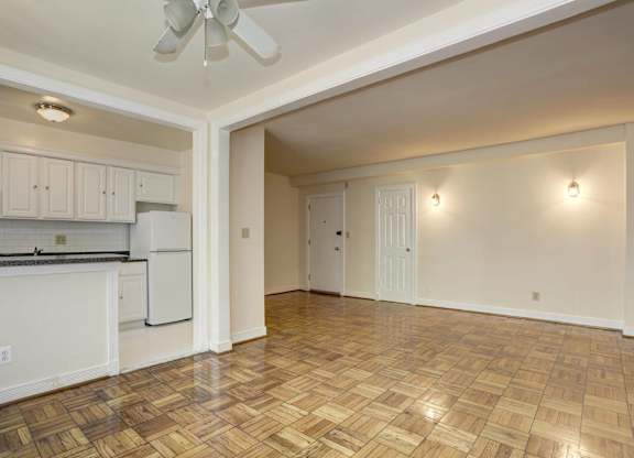 Open floor plan with parquet flooring and kitchen at Tivoli Gardens Apartments, Washington, DC
