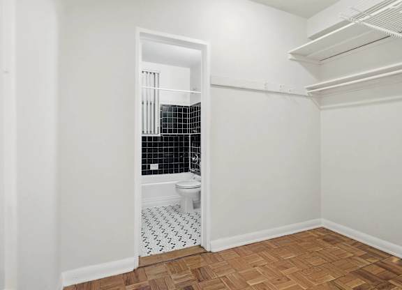 A bathroom with a toilet and a shower with a glass door.