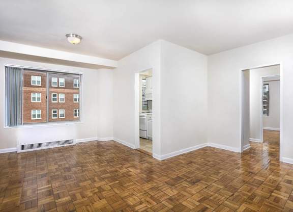 A room with a wooden floor and white walls.