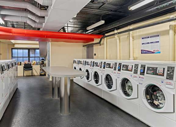 A row of washing machines in a public laundromat.