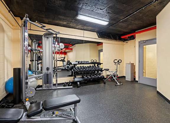 A gym with a variety of equipment including a leg press machine.