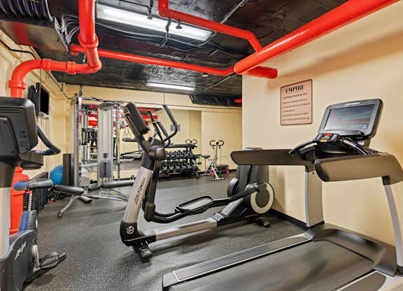 A gym with treadmills and elliptical machines.