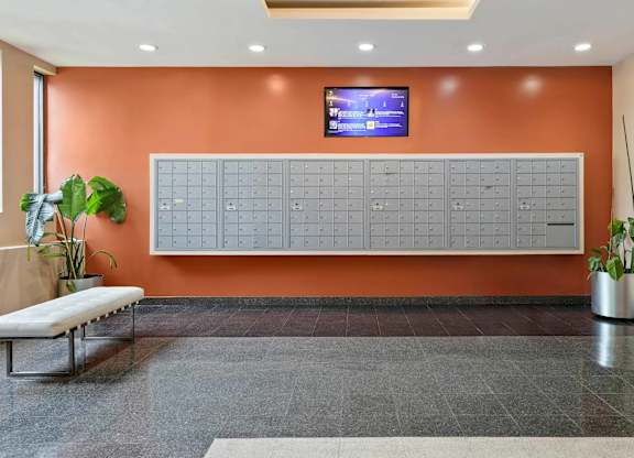A wall with a calendar on it and a TV above it.