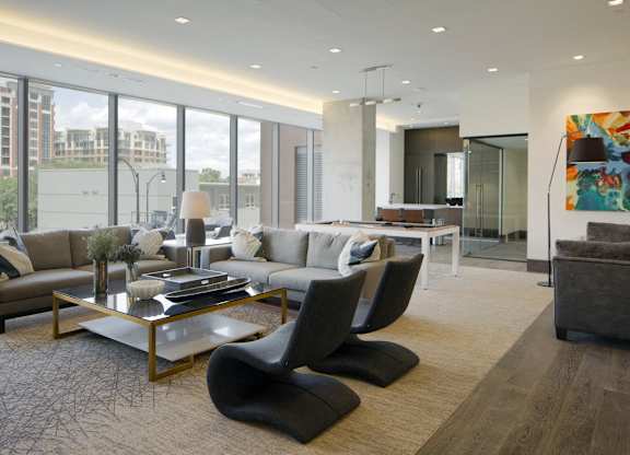 Modern living room with sectional sofa and city views at 1305 Dock Apartments, Baltimore, MD