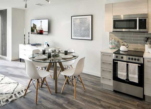 Modern open concept kitchen and dining space at 1305 Dock Apartments, Baltimore, MD