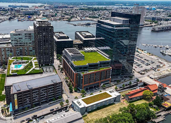 Aerial view of waterfront development with modern buildings at 1305 Dock Apartments, Maryland, 21231