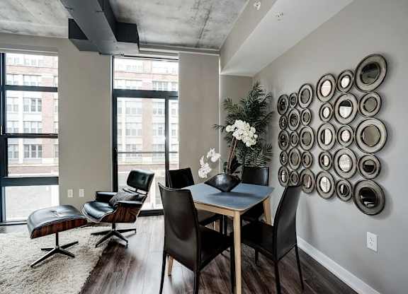 A dining room with a table and chairs.