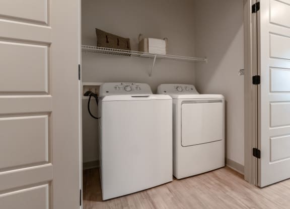 an empty laundry room with two washes and a dryer in it at Preston Ridge, Cary, NC