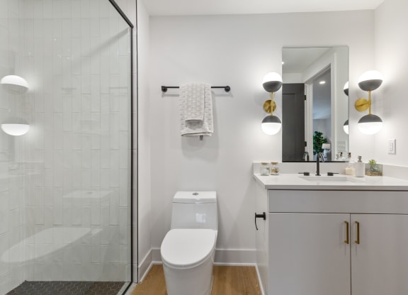 a white bathroom with a shower and a sink and a toilet at Rialto, Washington, DC 20002