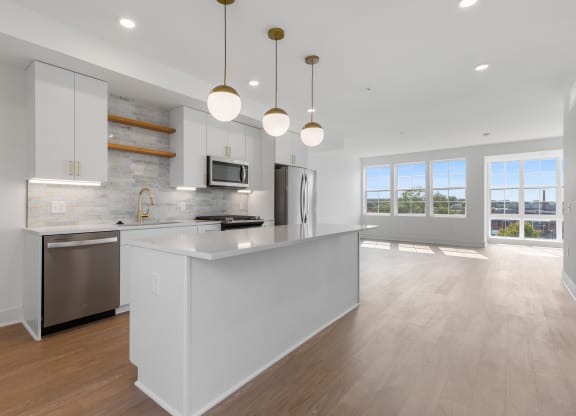 a large white kitchen with an island and stainless steel appliances at Rialto, Washington, DC