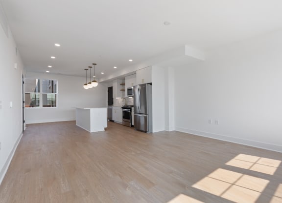 a renovated living room with a kitchen and a hard wood floor at Rialto, Washington