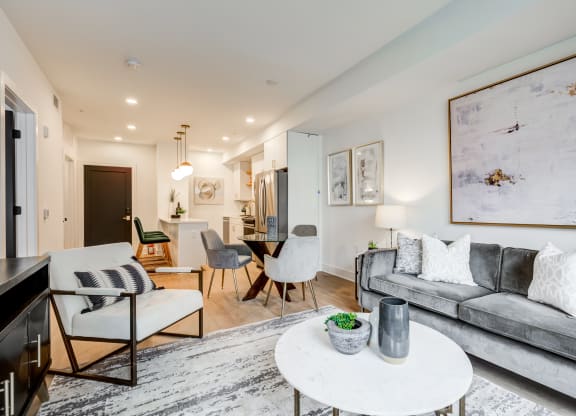 a living room with a gray couch and a white table at Rialto, Washington 