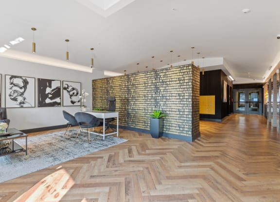 a living room with a table and chairs and a brick wall at Rialto, Washington, DC