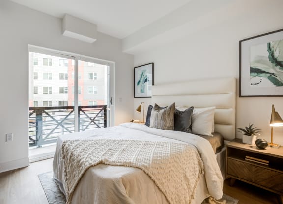 a bedroom with a bed and a sliding glass door to a balcony at Rialto, Washington District of Columbia