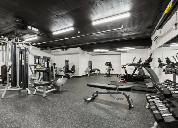 a gym with weights and other equipment in a building with black ceilings at Rialto, Washington, 20002