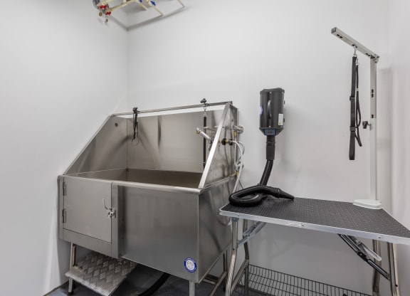 a stainless steel sink in a room with a phone on the wall at Rialto, District of Columbia