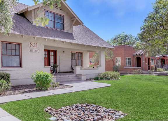 A house numbered 821 with a red door and a small garden in front at Roosevelt Commons Apartments, Phoenix, AZ, 85003