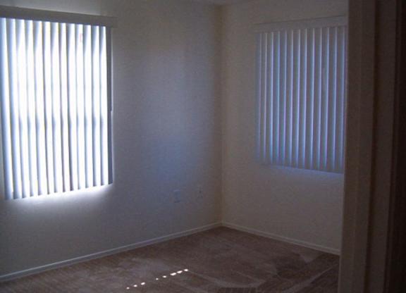 A room with a window on the left and a window on the right at Roosevelt Commons Apartments, Phoenix, AZ