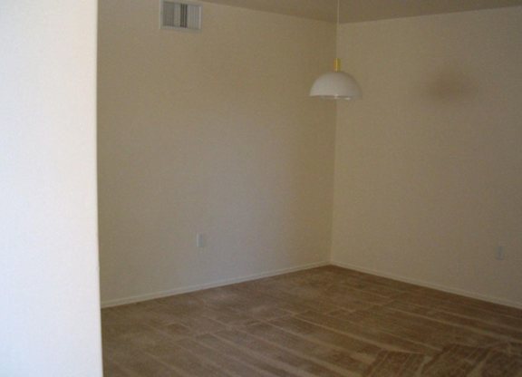 A room with a light hanging from the ceiling at Roosevelt Commons Apartments, Phoenix, AZ, 85003