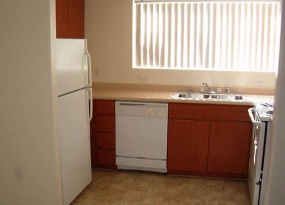 A kitchen with a white refrigerator and a white dishwasher at Roosevelt Commons Apartments, Arizona, 85003