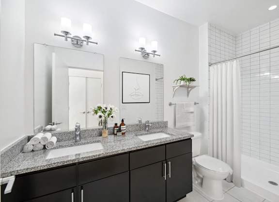 a bathroom with two sinks and a shower and a toilet at Fort Totten Square, Washington, 20011