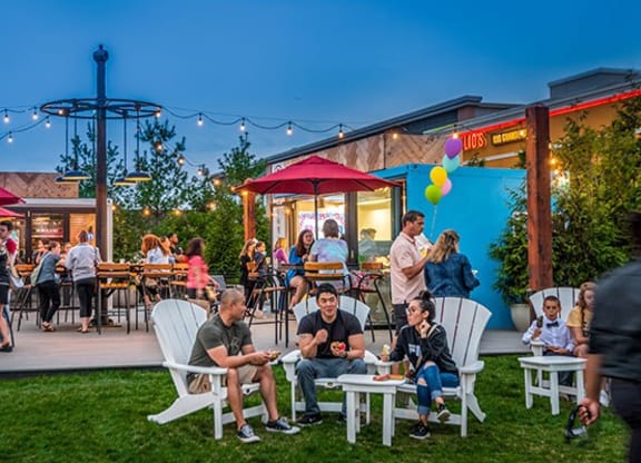 a group of people sitting and standing around a patio at Vyne One Loudoun, Ashburn, Virginia