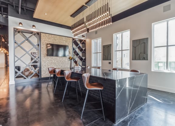 a kitchen with a marble counter top and a dining room with chairs at South and Hollis, Charlotte, NC, 28209