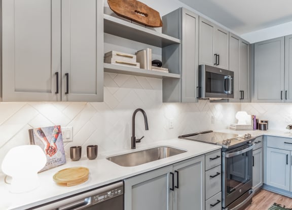a kitchen with blue cabinets and a sink at South and Hollis, Charlotte,NC