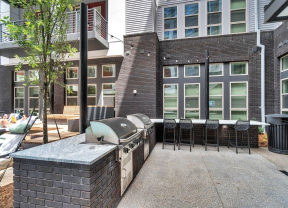 a patio with a grill and a table with chairs at South and Hollis, North Carolina, 28209