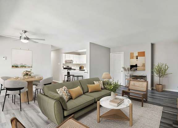 A living room with a green couch and a coffee table at The Overlook at Quantico Apartments, Triangle, VA, 22172