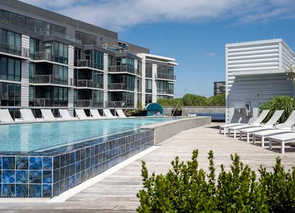 A modern building with a pool in front. at Dock 79, Washington, DC