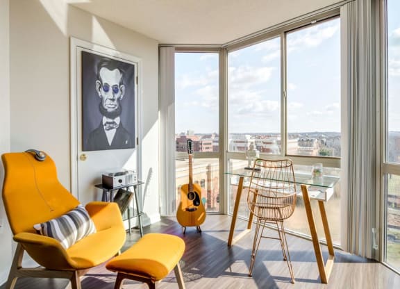 a living room with a guitar and a balcony at Lincoln Old Town, Alexandria, VA 22314